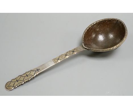 An 18th Russian white and parcel gilt metal ladle, the handle with a niello inlay and a coconut bowl. 28.5cms.