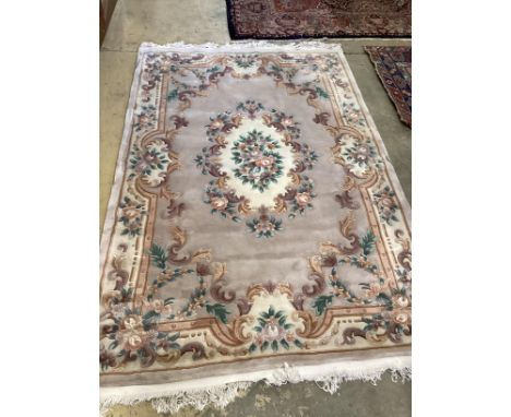 A Chinese fawn ground floral carpet, 275 x 184cm