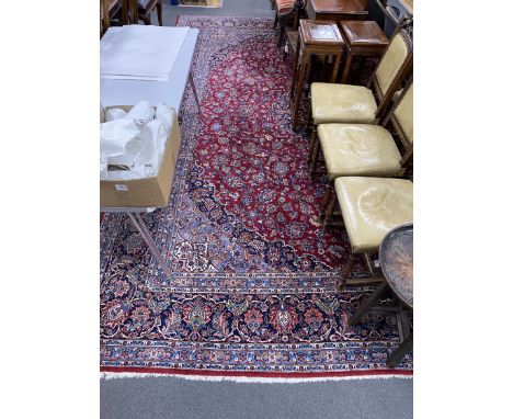 A Tabriz burgundy ground carpet, 460 x 330cm