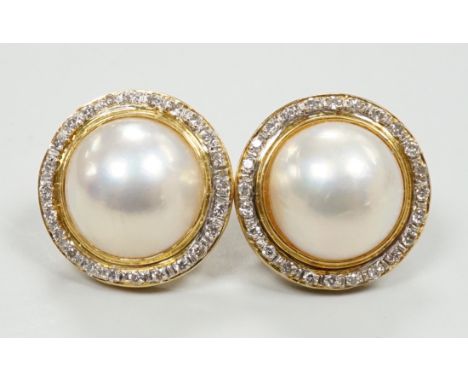 A pair of 750, mabe pearl and diamond cluster set circular earrings, diameter 18mm, gross weight 10.6 grams.