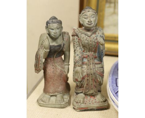 An Indonesian hand painted calendar and two similar figures, tallest 21cm