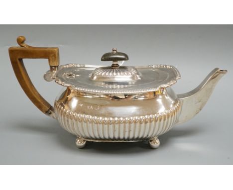 A Victorian demi-fluted silver teapot, Edward Hutton, London,  1883, gross weight 16oz.