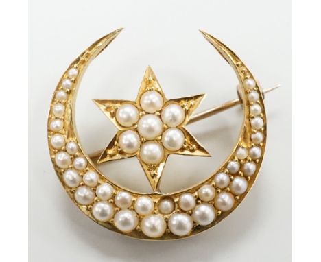 An Edwardian yellow metal and seed pearl set 'star and crescent moon' brooch, 26mm, 6.1 grams, in fitted case.