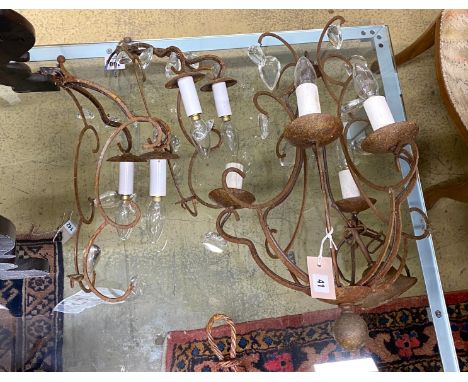 A wrought iron four branch ceiling light, hung oval glass drops, height 56cm together with a pair of matching two branch wall