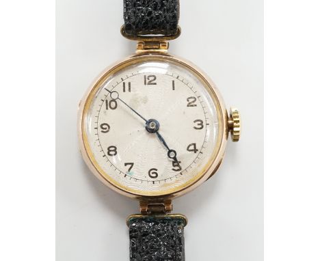 An early 20th century 9ct gold Rolex manual wind wrist watch, with Arabic dial, case diameter 27mm, on associated leather str