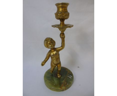 Cast brass on onyx base candlestick in the form of a cherub