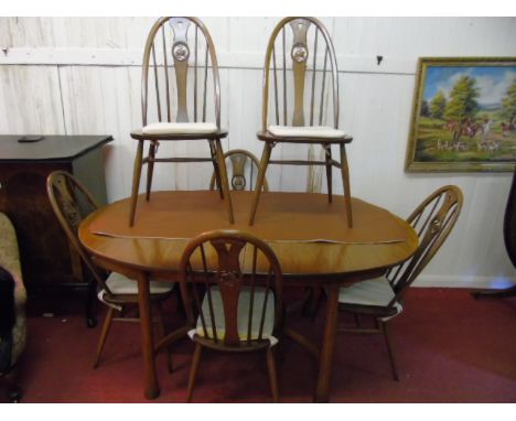 Ercol extending dining table and 6 swan back chairs all in golden dawn colour