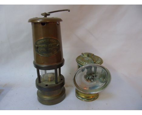 Small copper miners lamp together with a vintage carbide lamp
