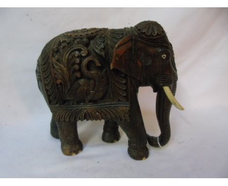 Antique carved elephant with ivory toes and tusk. Approx. 10" tall