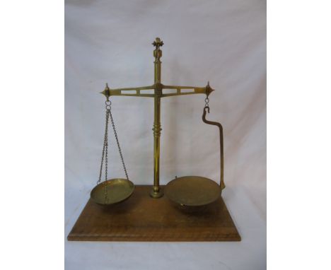 Set of vintage brass balance scales on wooden base