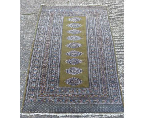 A Kelim style carpet with central medallions against a green ground, 184 x 127cm