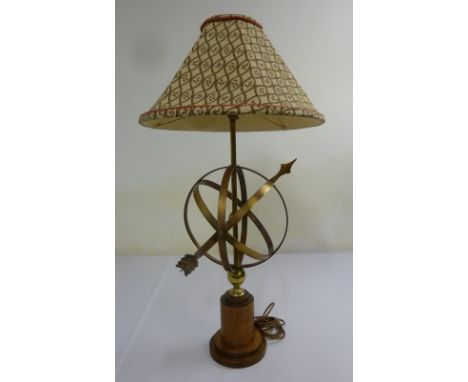 Brass table lamp in the form of a sundial on raised wooden stand with linen shade