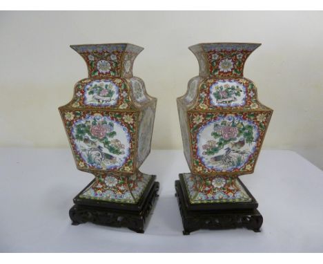 Pair of Oriental enamel vases decorated with birds, flowers and leaves on carved and pierced hardwood stands, 45cm(h) includi