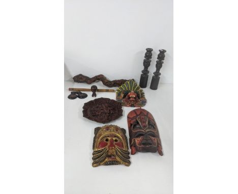 A mixed lot to include a Chinese cinnabar lacquered wall hanging plaque, wall hanging painted treen masks, and a corkscrew ma