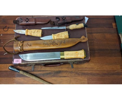 Three Helle Norwegian daggers, a paper knife and a swagger stick clad with fur, possibly monkey, 86cm lLocation:If there is n