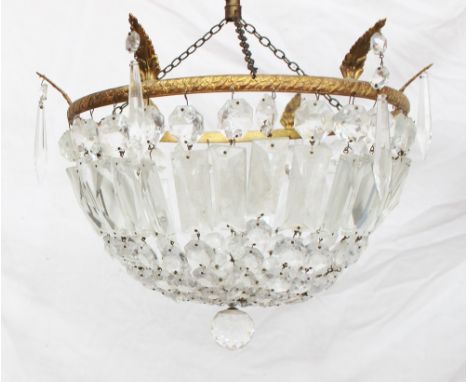 A lustre drop ceiling lamp shade, with cascading lustres attached to a gilt metal leaf moulded ring, 31cm diameter
