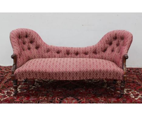 A Victorian rosewood double chair backed settee, with button back upholstery on turned legs and castors