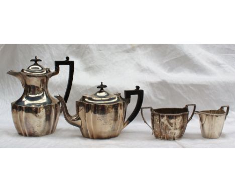 A George V silver four piece tea set of panelled form, comprising a hot water jug, teapot, cream jug and sugar basin,  Sheffi