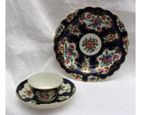 An 18th century Worcester polychrome decorated shallow bowl painted with sprays of garden flowers to a gilt highlighted scale