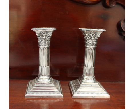 A pair of late Victorian silver stop fluted Corinthian column desk candlesticks, with stepped square base, Sheffield, 1892, H