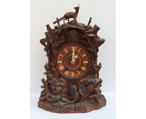 A late 19th / early 20th century Black Forest Cuckoo bracket clock the surmount carved with a deer, leaves and tree stump, ab