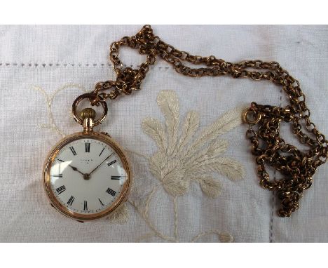 A ladies yellow metal fob watch marked 14k, the enamel dial with Roman numerals on a yellow metal chain 