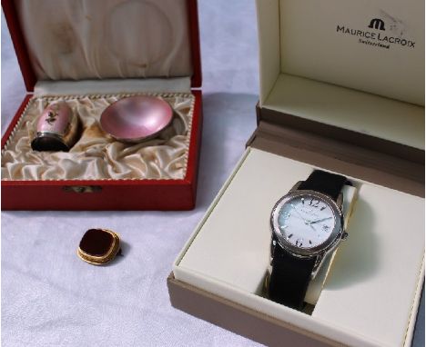 A Maurice Lacroix stainless steel lady's wristwatch the white dial with Arabic numerals and batons and a date aperture, boxed