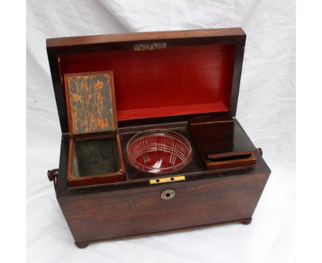 A Victorian rosewood sarcophagus tea caddy, with ring turned handles on flattened bun feet, enclosing two lidded compartments