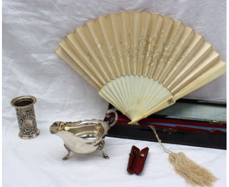 A George V Silver sauce boat with a leaf capped scrolling handle on three shell capped feet, Sheffield, 1929, together with a