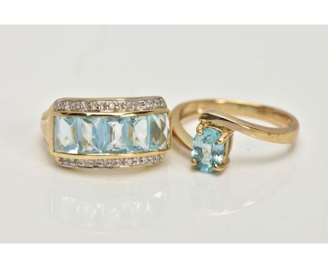 TWO 9CT GOLD GEM SET DRESS RINGS, the first centring on a slightly raised row of five rectangular, mix cut light blue topaz, 