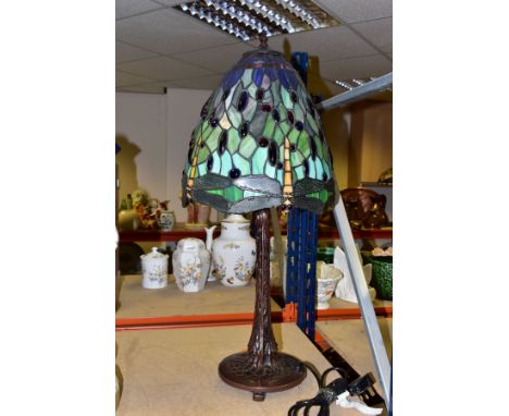 A TALL MODERN TIFFANY STYLE LAMP, with a green glass shade decorated with dragonflies and glass cabochons, over a dark brown 