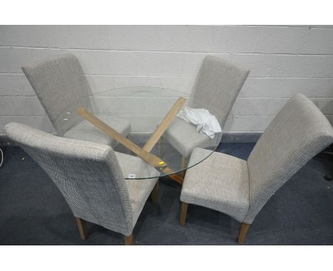 A CIRCULAR GLASS TOP DINING TABLE, on a cross framed oak base, diameter 120cm x height 76cm, along with four light grey uphol