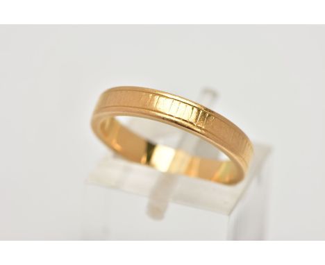 A YELLOW METAL BAND RING, worn engraved detail all round, ring size M leading edge, unmarked, approximate gross weight 4.6 gr
