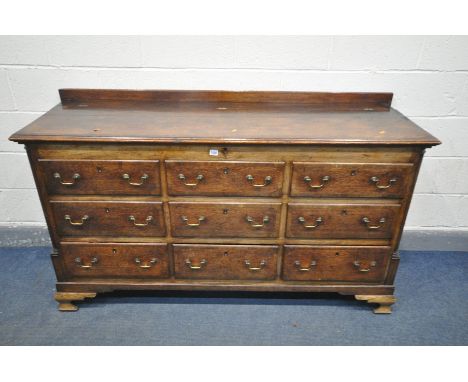 A GEORGIAN OAK AND CROSSBANDED LANCASHIRE CHEST, with hinged lid, six dummy drawers above three short drawers, all with swan 