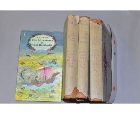 A THREE VOLUME SET OF THE LORD OF THE RINGS BY JRR TOLKIEN, published by Readers Union in 1960, all with chipped/torn dust ja
