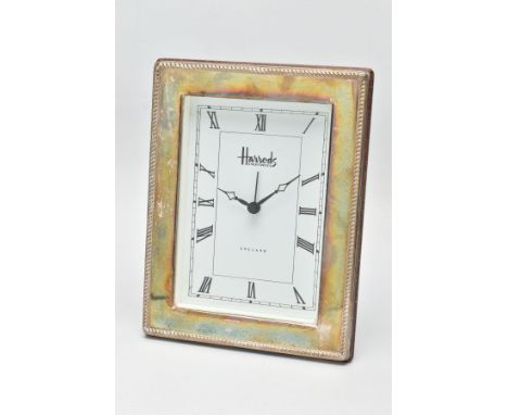 A SILVER 'HARRODS' MANTLE CLOCK,  a rectangular form clock, white face signed 'Harrods Knightsbridge' 'England', roman numera