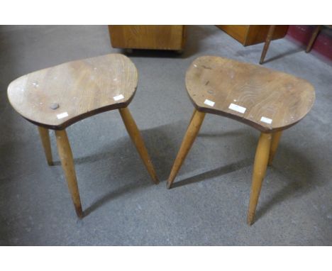A pair of Ercol Blonde elm and beech saddle stools 