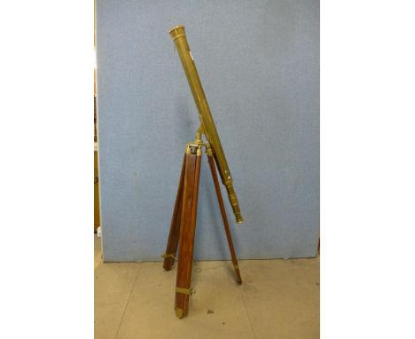 A brass telescope on tripod stand 