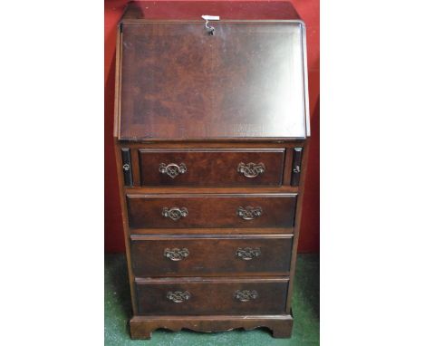 A 20th century Norwegian walnut and mahogany bureau, of narrow proportions, fall front enclosing a writing surface and fitted