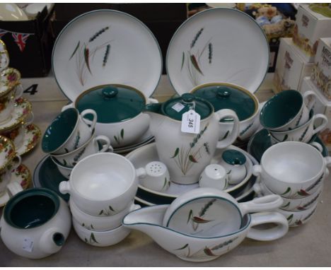 A Denby Greenwheat pattern part dinner and tea set comprising dinner plates, side plates, serving dishes, vegetable dishes, s