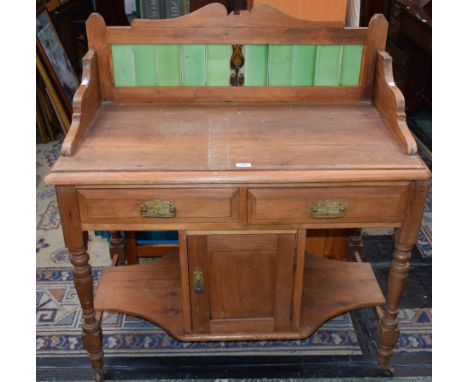 An early 20th century pine washstand, tiled three quarter gallery back, moulded rectangular top above a pair of frieze drawer