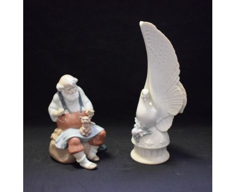 A Lladro ceramic figure, Santa's Magic Touch, 06774, boxed; another, Message of Love, 06643, boxed (2) 