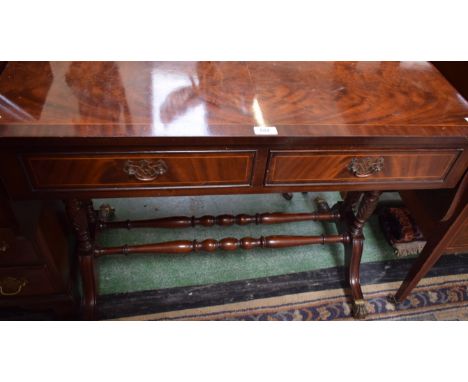 A reproduction mahogany sofa table, shaped rectangular top with fall leaves above a pair of frieze drawers, turned supports a