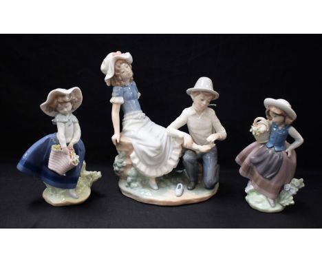 A Nao figure group, the Hurt Foot; two Lladro figures, girls with flower baskets (3)