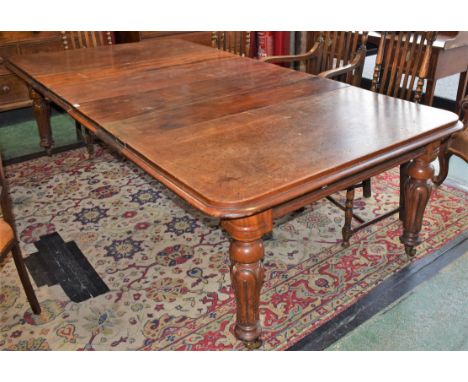 A 19th century mahogany extending dining table, associated leaves, turned tulip carved legs, ceramic casters, extends to 255c