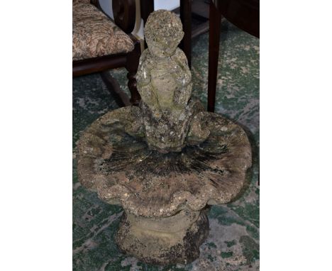 A reconstituted stone birdbath, cast with boy and pan pipe sat on a shell, 75cm high