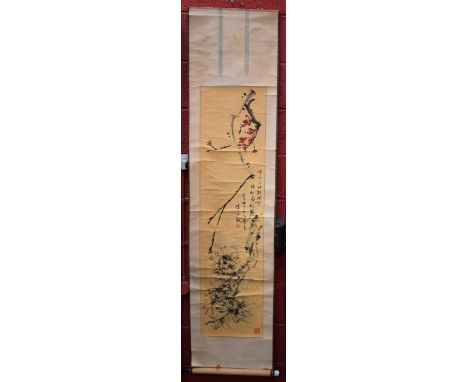 A Chinese scroll, decorated with blossoming prunus, 129cm x 32cm, hardwood mount