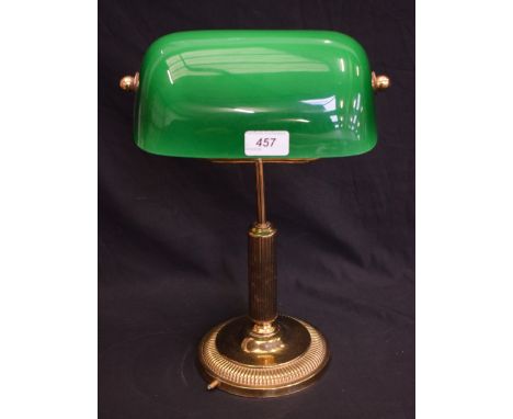 A brass desk lamp, with green glass shade