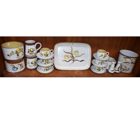 A Denby Pottery stoneware part dinner and tea service, painted with yellow flowers, brown and green leaves, including rounded