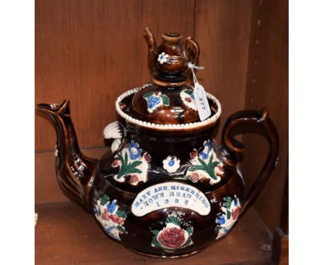 A large Bargeware treacle glaze teapot and cover, Mary Ann Kirkbride, Town Head 1886, the domed cover with teapot finial, 31c